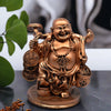 Laughing Buddha Sitting on Money Coins for Good Luck